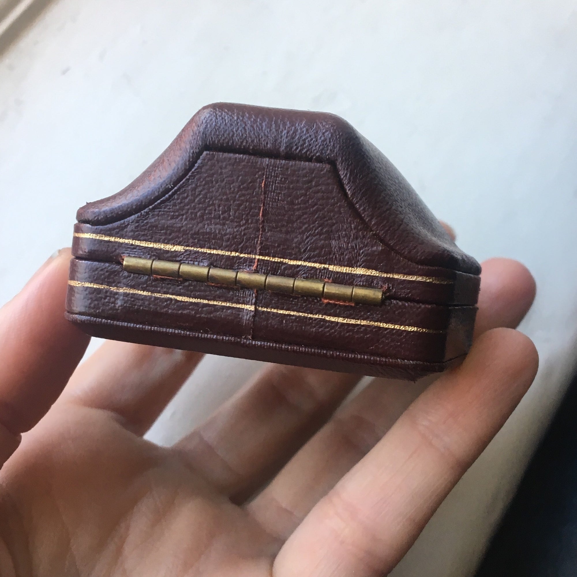 Domed leather boxes with gold trim detail