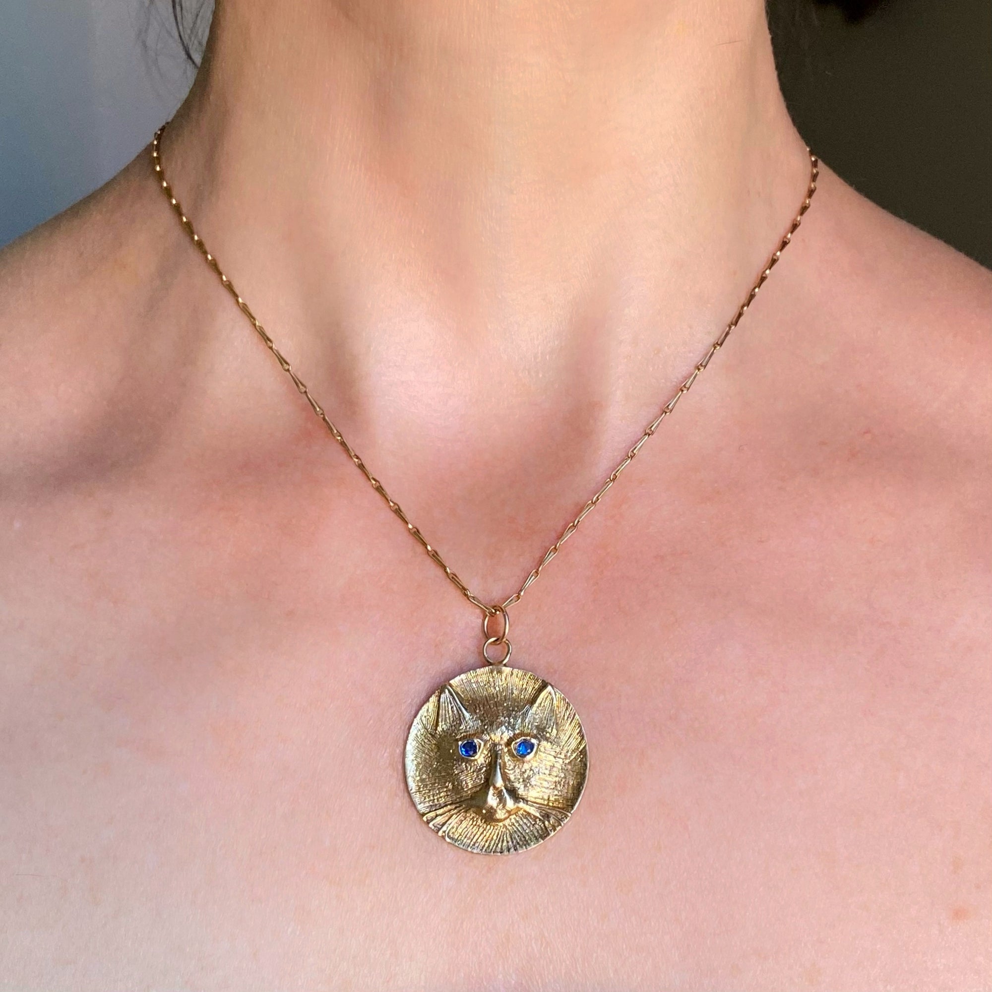 gold cat medallion